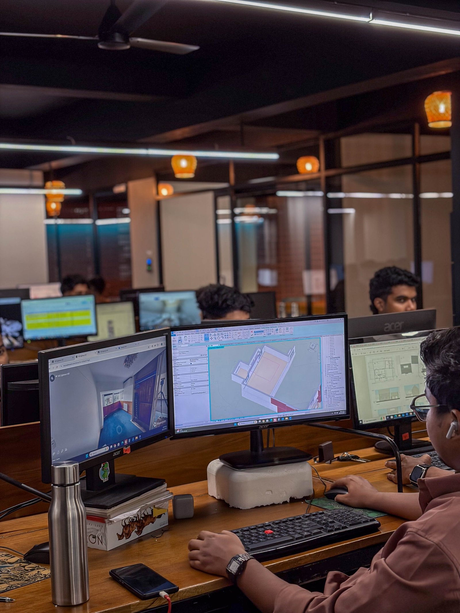 MJ Designs specialist reviewing BIM information at a Revit workstation