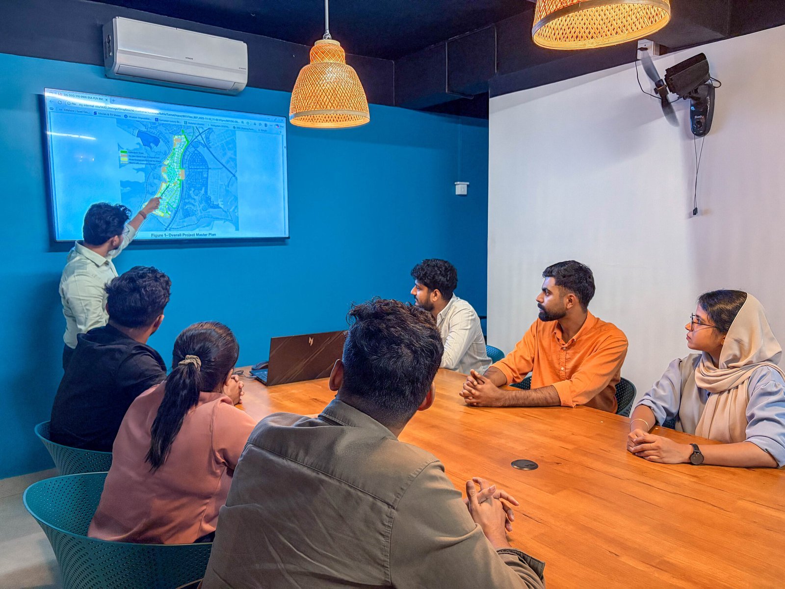 MJ Designs team discussing a project brief in the Manjeri office